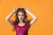 © Pixel-Shot - Surprised young woman with stylish hairdo on color background