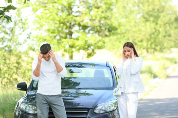 Wall Mural - Young couple near broken car on road