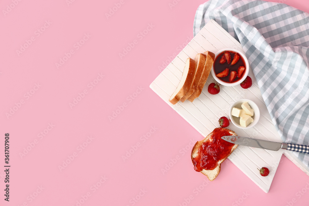 Board with tasty strawberry jam, bread and butter on color background