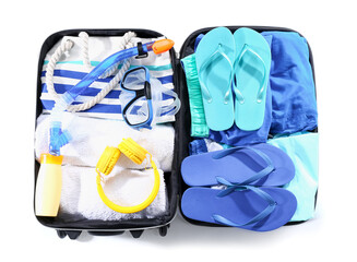 Packed suitcase with beach accessories on white background. Travel concept