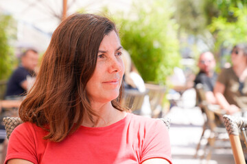 woman sitting outside in terrace coffee shop restaurant