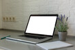 © Angelov - Laptop with blank screen on table.