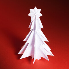Wall Mural - Christmas trees made of paper on red background. Christmas card