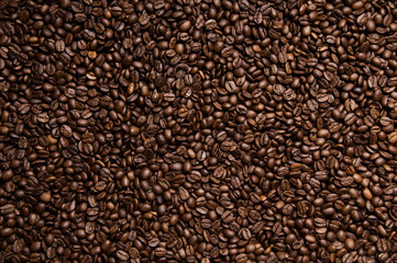 Roasted coffee beans background - full frame detail. Close up of a brown surface texture of aroma black caffeine drink ingredient for coffee beverage