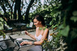 © bnenin - Summer vacation concept. Relaxing in garden cafe, using laptop.