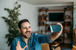 © bnenin - Portrait of a cheerful man having video call on smart phone.