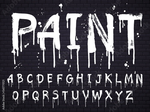 Fotomural Paint dripping paint font for latin alphabet isolated on dark background with bricks