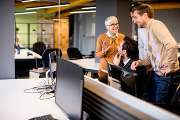 Wall Mural - Senior businesswoman working together with young business people in office