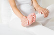 © fotoduets - Pregnant young woman sitting in bed and massaging her painful foot. Body health problem in pregnancy time. Close up.