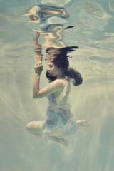 Wall Mural - Portrait of a girl in a dress under water in bright colors