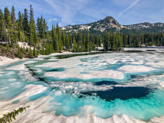 Wall Mural - a warm summer day helps speed the melting of snow and surface ice on a high mountain lake.