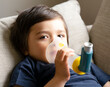 © Anchalee - Poor boy have a problem with chest coughing holding inhaler mask, Child using the volumtic for breathing treatment, Kid having asthma allergy using the asthma inhaler, Healthcare and medicine concept