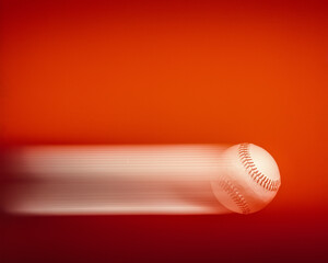 Wall Mural - baseball in motion with motion streaks on a red background 