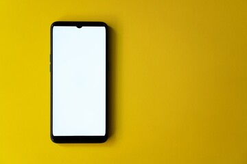 Wall Mural - Smartphone isolated on a yellow background