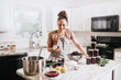 © MeganBetteridge - Woman canning homemade blackberry jam in home kitchen