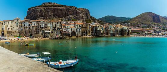 A panorama view across the old harbour and town of Cefalu, Sicily in summer