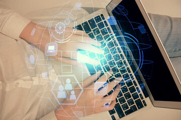 Double exposure of woman hands working on computer and social network theme hologram drawing. Top View. People connection concept.