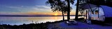 Fototapeta  - Travel trailer camping by the Mississippi river at sunset in Thomson Causway Illinois 