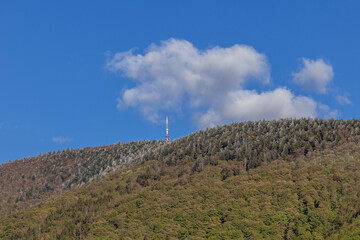 Wall Mural - Mountainous landscape and Radhost hill during a sunny day with clouds in the sky.