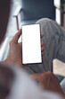 © tippapatt - Mockup of man hand holding and using mobile phone