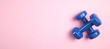 © andranik123 - Blue dumbbells on pink background.