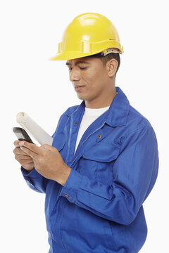 Construction worker sending a text message