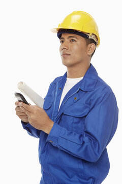 Construction worker sending a text message