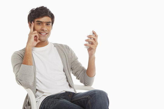 Man sitting on a chair, text messaging