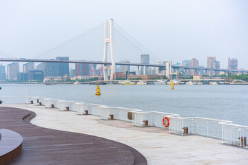 The expo park along the Huangpu River,  with Nanpu bridge in the back, shot in Shanghai, China.