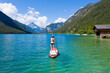 woman with bikini on lake plansee with SUP in wonderful nature on sunny day