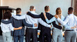 © Prostock-studio - Business Team Embracing Standing Back To Camera In Office, Panorama
