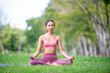 © NITIKAN T. - Asian model poses yoga in a park on a natural green background, health care concept, beautiful body structure, fit body