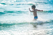 © Olivia - A little boy on the beach, playing with the waves