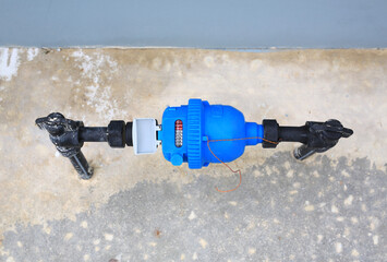 water meter and valve installed on cement floor. Top view