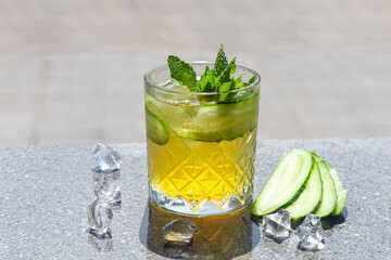 Refreshing summer strong cocktails with a slice of lime. Alcoholic drink. Garnished with a sprig of mint, citrus and ice cubes. In the bar.