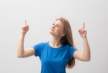 Shall we. Enthusiastic attractive blonde young woman look up curious pointing right and left index fingers up smiling happy excited content stare asking opinion standing white background intrigued