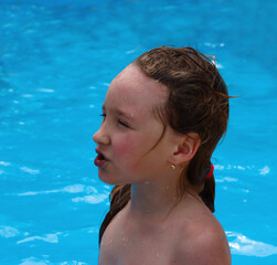 a girl is swimming in the pool.