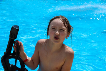 a girl in a mask swims in the pool.
