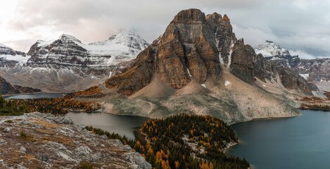 panoramic view of mountain peaks in fall with orange larches