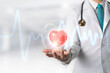 © jayzynism - Medicine doctor holding red heart shape in hand with Technology Innovation and medicine concept.