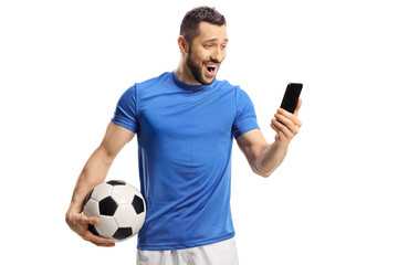 Canvas Print - Surprised soccer player holding a ball and looking at a mobile phone