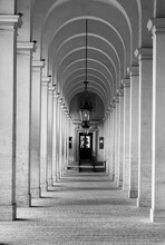 Black And White Photo Showing Long Hallway With Marble Columns