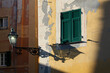 Old window with street lamp and shadow on Ligurian village. Architectural details of Camogli, Genova Liguria.