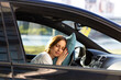 © DimaBerlin - Tired young woman asleep on pillow on steering wheel, resting after long hours driving a car. Fatigue. Sleep deprivation.