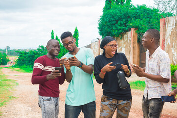 young black friends taking a stroll and checking out things on their smartphones