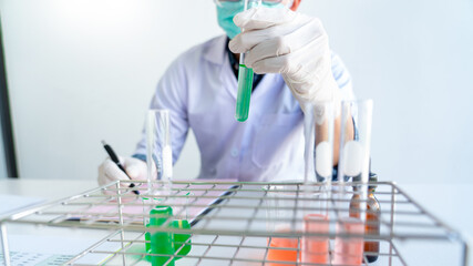 Asian scientist doing research for analyzing a Experiments sample in laboratory.