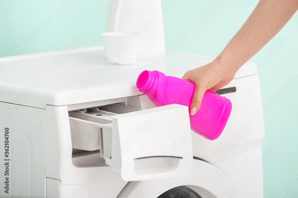 Woman doing laundry at home, closeup