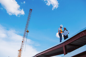 Wall Mural - Project engineer, engineer working on blueprint architectural project at construction site