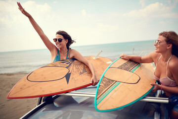 Wall Mural - Sexy female surfers preparing for a trip