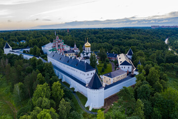 ancient white stone fortress at dawn taken from a drone